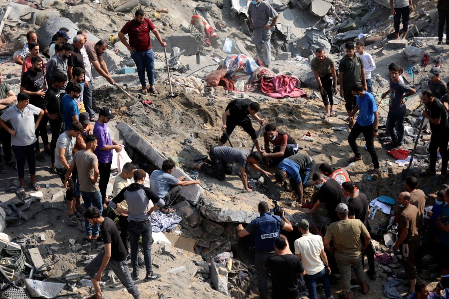 FILE - Palestinians work among debris of buildings that were targeted by Israeli airstrikes in Jabaliya refugee camp, northern Gaza Strip, Nov. 1, 2023. The White House says Israel has agreed to put in place four-hour daily humanitarian pauses in its assault on Hamas in northern Gaza. (AP Photo/Abed Khaled, File)