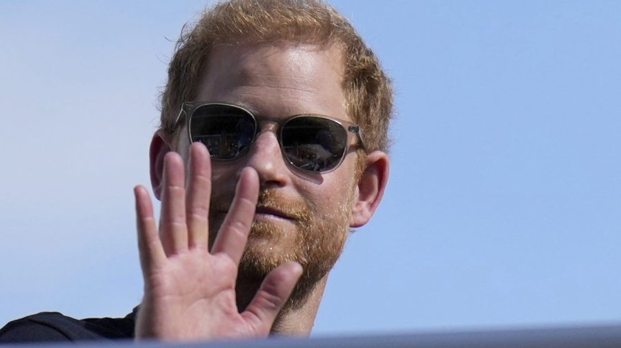 FILE - Britain's Prince Harry, The Duke of Sussex, waves during the Formula One U.S. Grand Prix auto race at Circuit of the Americas, on Oct. 22, 2023, in Austin, Texas. A British judge ruled Friday that a lawsuit by Prince Harry, Elton John and five other celebrities accusing a newspaper publisher of unlawful information-gathering should go to a full trial. The claimants, who include John’s husband David Furnish and actors Liz Hurley and Sadie Frost, accuse the publisher of the Daily Mail of paying private investigators to illegally bug homes and cars and to record phone conversations. (AP Photo/Nick Didlick, File)