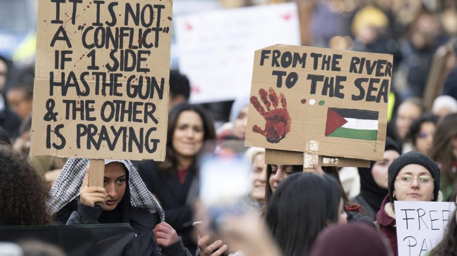 Young women hold placards during a pro-Palestinian demonstration, in Frankfurt, Germany, Friday, Nov. 3, 2023. The Jordan River is a winding, 200-plus-mile run to the east of Israel and the West Bank. The sea is the glittering Mediterranean to its west. But a phrase about the space in-between, “from the river to the sea,” has become a battle cry with new power to roil Jews and pro-Palestinian activists in the aftermath of Hamas’ murderous rampage across southern Israel Oct. 7 and Israel’s bombardment of Gaza. (Boris Roessler/dpa via AP)