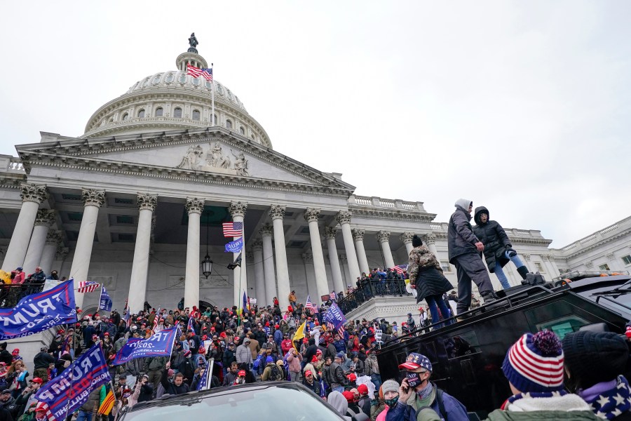 FILE - Rioters loyal to President Donald Trump stand on vehicles and the steps of the U.S. Capitol on Jan. 6, 2021, in Washington. Jason Donner, a former Fox News producer says in a lawsuit filed Monday, Nov. 13, 2023, he was targeted and fired for pushing back against false claims about the riot at the U.S. Capitol on Jan. 6. Donner said he was part of a “purge” of employees who refused to report information that would please Trump and his supporters. Donner was inside the Capitol during the riot and pressed his complaints about the networks coverage for months(AP Photo/Julio Cortez, File)