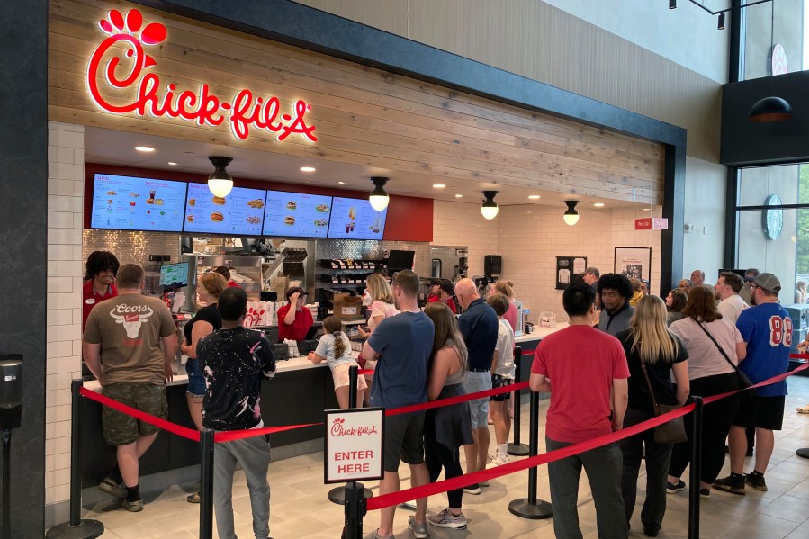 File - People line up to order fast food from a Chick-fil-A restaurant at the Iroquois Travel Plaza rest stop on the New York State Thruway in Little Falls, New York, on June 30, 2023. On Tuesday, the Labor Department issues its report on inflation at the consumer level in October. (AP Photo/Ted Shaffrey, File)