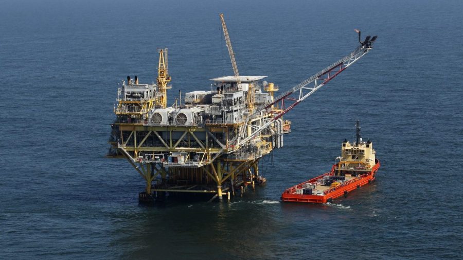 FILE - A rig and supply vessel are pictured in the Gulf of Mexico, off the cost of Louisiana, April 10, 2011. An auction of federal Gulf of Mexico leases for oil and gas drilling must be held in 37 days, a federal appeals court ruled Tuesday, Nov. 14, 2023, rejecting environmentalists arguments against the sale, and throwing out plans by the Biden administration to scale back the sale to protect an endangered species of whale. (AP Photo/Gerald Herbert, File)