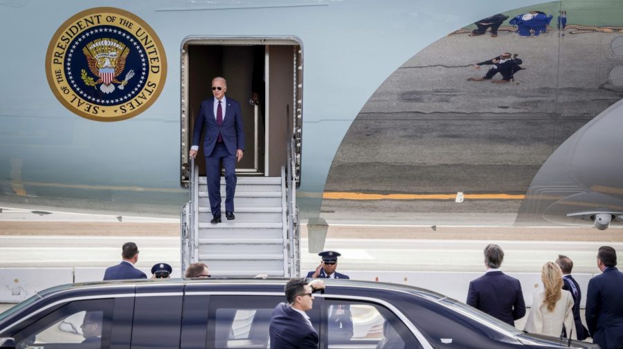 President Joe Biden walks down the steps of Air Force 1 at San Francisco International Airport as Asia-Pacific Economic Cooperation (APEC) kicks off in San Francisco, Tuesday, Nov. 14, 2023. Biden was greeted by California Gov. Gavin Newson, fourth right, first partner, Jennifer Siebel Newson, third right, Rep. Kevin Mullin, right, and others. (Brontë Wittpenn/San Francisco Chronicle via AP)