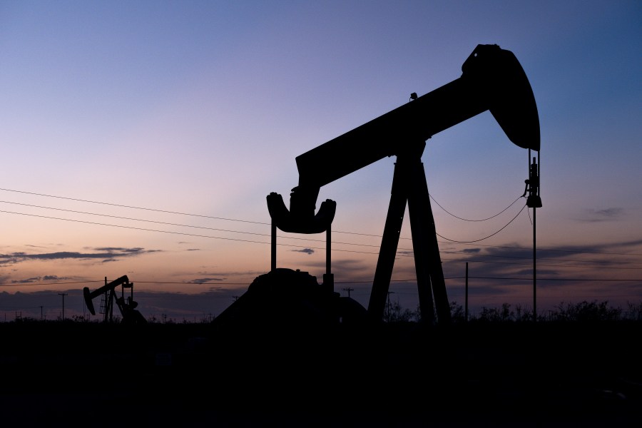 FILE -The sun sets behind a pair of pumpjacks Wednesday, Sept. 15, 2021 in the oilfields of Penwell, Texas. How science textbooks in Texas address climate change is at the center of a key vote expected Friday, Nov. 17, 2023 after some Republican education officials criticized books for being too negative toward fossil fuels in America's biggest oil and gas state. (Eli Hartman/Odessa American via AP, File)