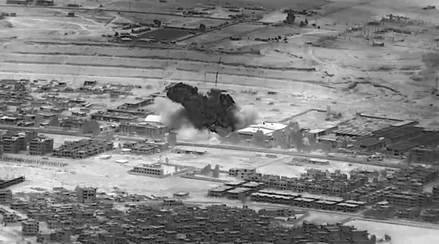 This image from video provided by the Department of Defense shows a Nov. 8, 2023, airstrike on a weapons warehouse. center, in eastern Syria. The strike targeted a facility linked to Iranian-backed militias, in retaliation for what has been a growing number of attacks on bases housing U.S. troops in the region for the past several weeks. Iranian-backed militants in Iraq and Syria have long battled with U.S. and coalition forces, launching sporadic attacks against bases in the region where troops are deployed to fight Islamic State group insurgents. (Department of Defense via AP)