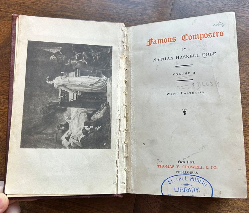 In a photo provided by the St. Paul Public Library is a book, "Famous Composers,” that was recently returned to the library in St. Paul, Minn. The tome turned up while someone was sorting through a relative’s belongings. The St. Paul Public Library checkout slip shows it was last borrowed in 1919, Minnesota Public Radio reports. (Claire Huber/St. Paul Public Library via AP)