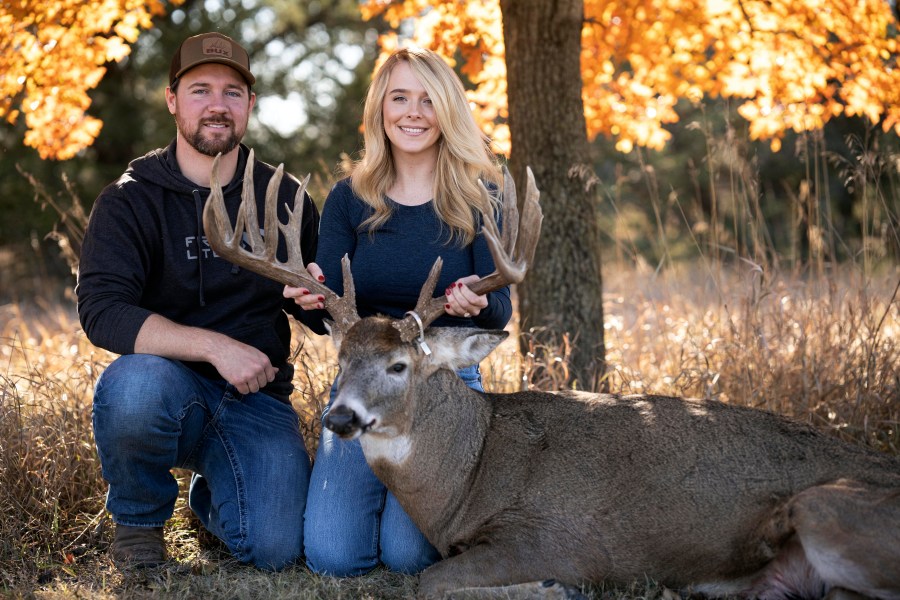 Cole Bures and Samantha Camenzind pose with the deer she shot near Filley, Neb., before he proposed to her on Nov. 12, 2023. Bures asked Camenzind to marry him during a photo shoot to commemorate the moment. (Brenton Lammers/Lammers Media via AP)