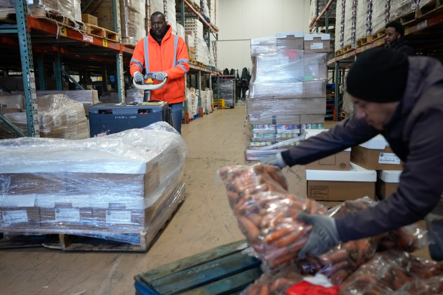 Prince Swain, left, and Carlos Quezada load food onto trucks at Feeding Westchester in Elmsford, N.Y., Wednesday, Nov. 15, 2023. A growing number of states are working to keep food out of landfills over concerns that it is taking up too much space and posing environmental problems. Some states including New York are requiring supermarkets and other businesses to redirect food to food pantries. (AP Photo/Seth Wenig)