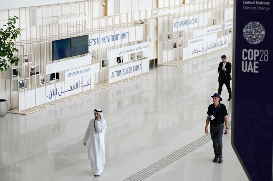 People walk in the venue ahead of the COP28 U.N. Climate Summit, Tuesday, Nov. 28, 2023, in Dubai, United Arab Emirates. (AP Photo/Peter Dejong)
