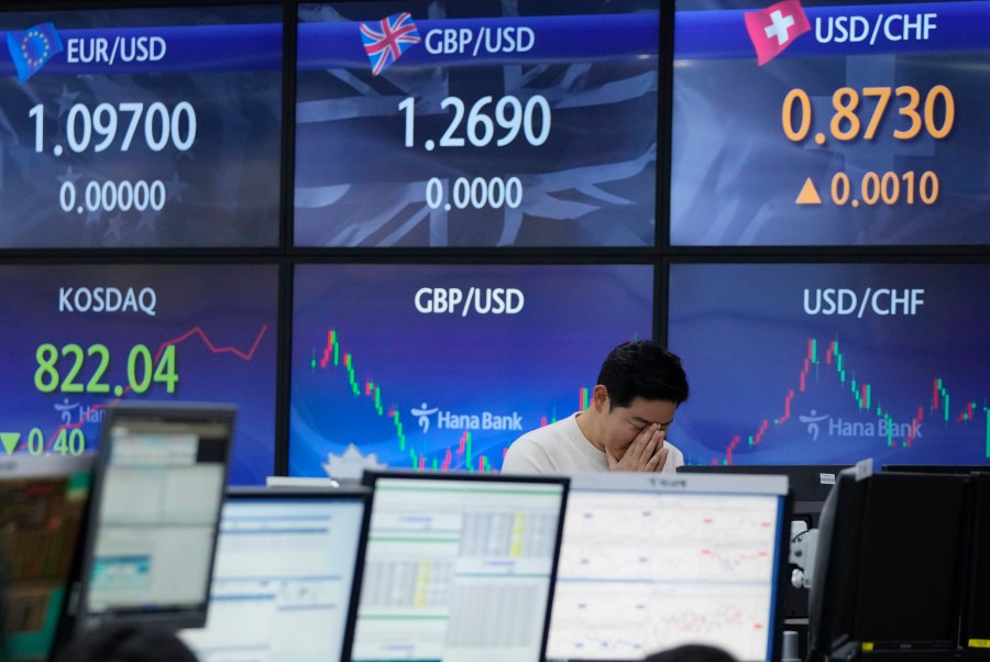 A currency trader reacts near the screens showing foreign exchange rates at the foreign exchange dealing room of the KEB Hana Bank headquarters in Seoul, South Korea, Thursday, Nov. 30, 2023. Asian shares were mostly higher Thursday ahead of an update on U.S. consumer inflation and a meeting of oil producers in Vienna. (AP Photo/Ahn Young-joon)