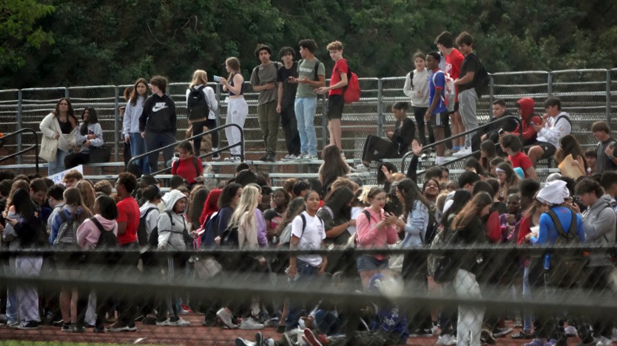 Students from Monarch High School in Coconut Creek, Fla., walk out of the school building Tuesday, Nov. 28, 2023, in support of a transgender student who plays on the girls volleyball team. The school principal and other administrators were removed from their positions for allowing the student to participate in the activity.