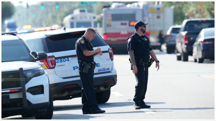 Jacksonville police officers block the perimeter of the scene of a mass shooting, Saturday, Aug. 26, 2023, in Jacksonville, Fla. (AP Photo/John Raoux)