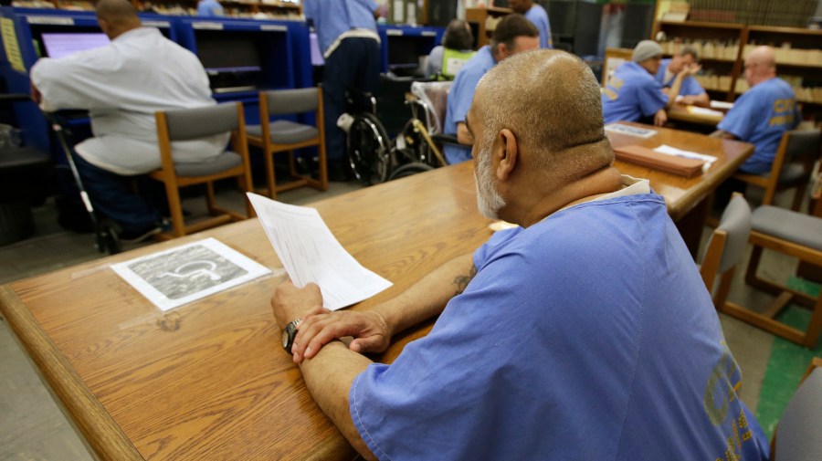 In this photo taken June 20, 2018, inmates use the library at the California Medical Facility in Vacaville, Calif.