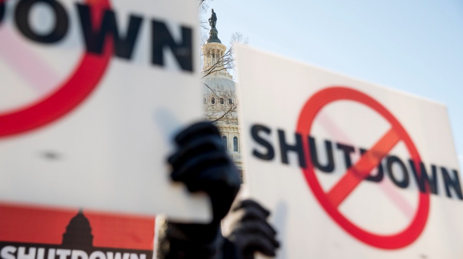 The Capitol Dome is visible behind signs as Air Traffic and Pilot unions protest the government shutdown on Capitol Hill in Washington, Thursday, Jan. 10, 2019.