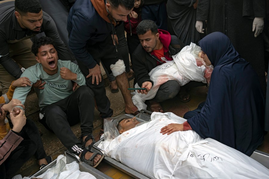 Palestinians mourn their relatives killed in an Israeli army bombardment of the Gaza Strip, outside the hospital in Khan Younis, Tuesday Dec. 5, 2023. (AP Photo/Fatima Shbair)