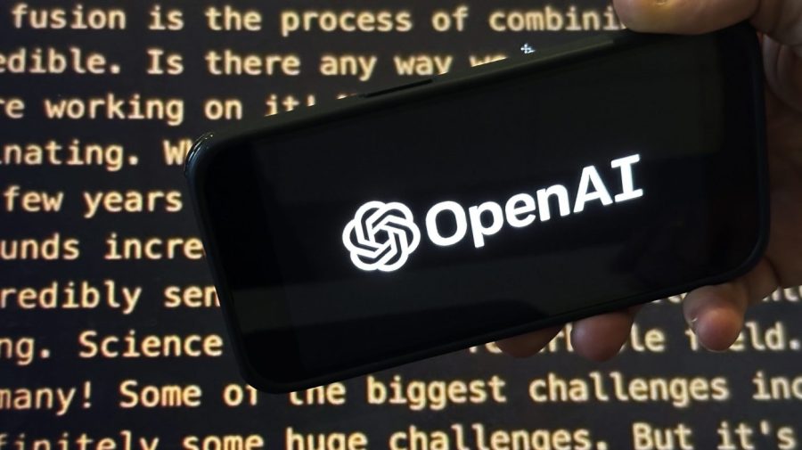 File - The OpenAI logo appears on a mobile phone in front of a screen showing part of the company website in this photo taken on Nov. 21, 2023 in New York. (AP Photo/Peter Morgan, File)