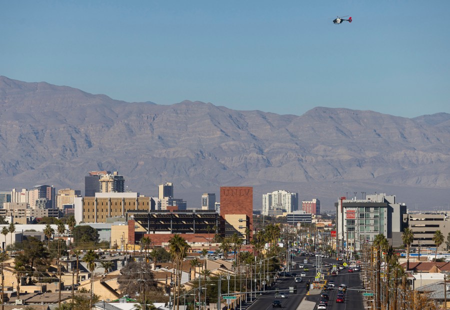 A police helicopter flies overhead during a shooting on the University of Nevada, Las Vegas, campus on Wednesday, Dec. 6, 2023, in Las Vegas. (Chase Stevens/Las Vegas Review-Journal via AP)