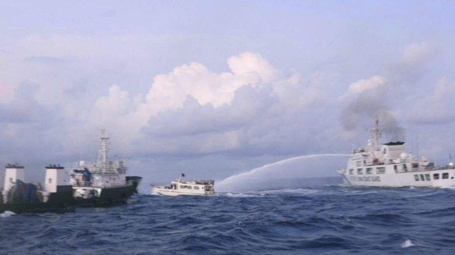 A Chinese Coast Guard ship uses water cannons on a Philippine navy-operated supply boat.