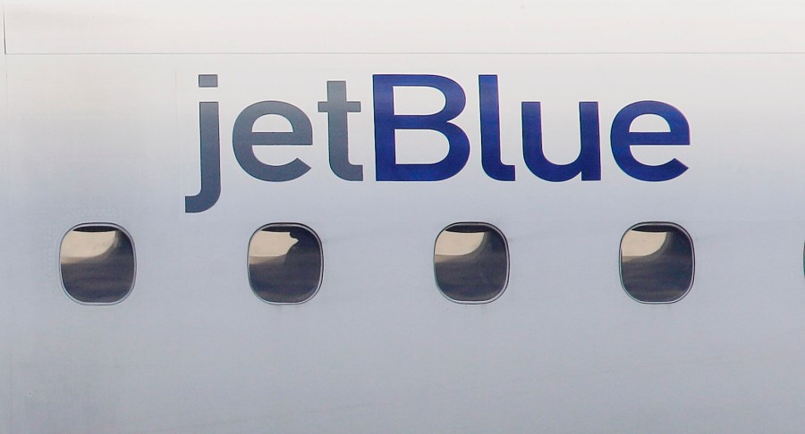 FILE - In this Jan. 20, 2011, file photo, a JetBlue logo is displayed on the side of a jet as it taxis at Boston's Logan International Airport. Federal investigators are describing a close call between planes at a Colorado airport last year. The National Transportation Safety Board said Wednesday, Dec. 13, 2023 that a JetBlue plane struck its tail on the ground because the captain took off quickly to avoid a plane that was preparing to land on the same runway. (AP Photo/Stephan Savoia, File)