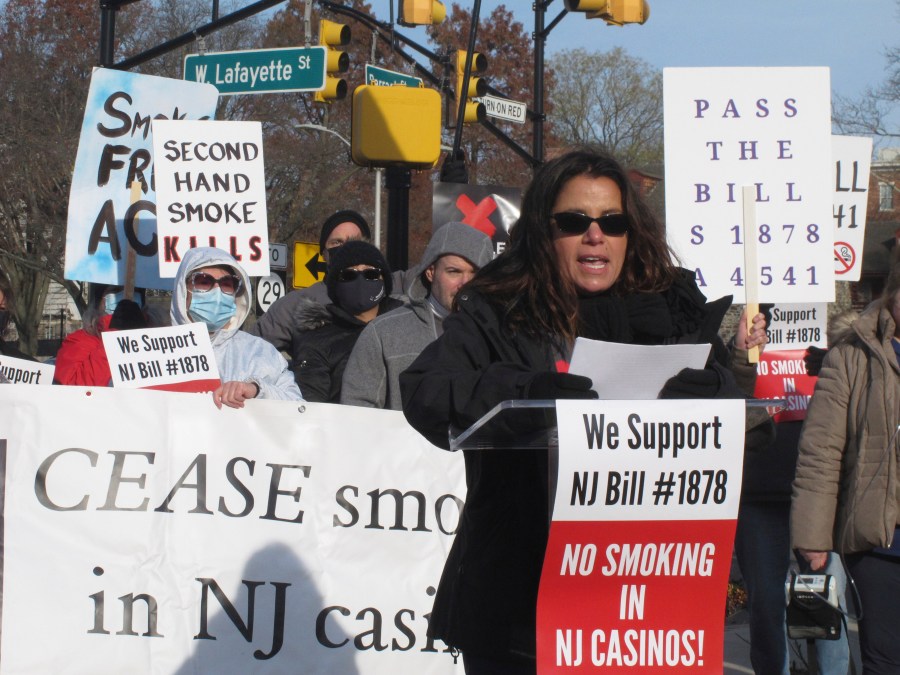 FILE - Nicole Vitola, a dealer at the Borgata casino, speaks at a protest outside the state capitol in Trenton N.J., Dec. 9, 2021, to call on the state Legislature to permanently ban smoking in the casinos. State Sen. Vince Polistina said on Dec. 14, 2023, that legislation lacks enough support to become law, and said he will write a new bill incorporating proposals form the casino industry, including enclosed smoking rooms. (AP Photo/Wayne Parry, File)