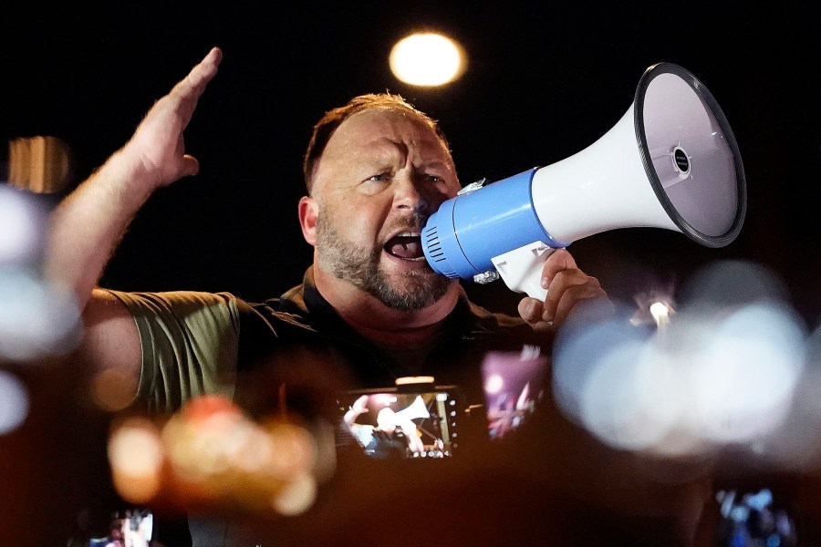 FILE - Infowars host and conspiracy theorist Alex Jones rallies pro-Trump supporters, Nov. 5, 2020, in Phoenix. A court upheld $75,000 in fines against Jones for missing Sandy Hook case deposition. (AP Photo/Matt York, File)