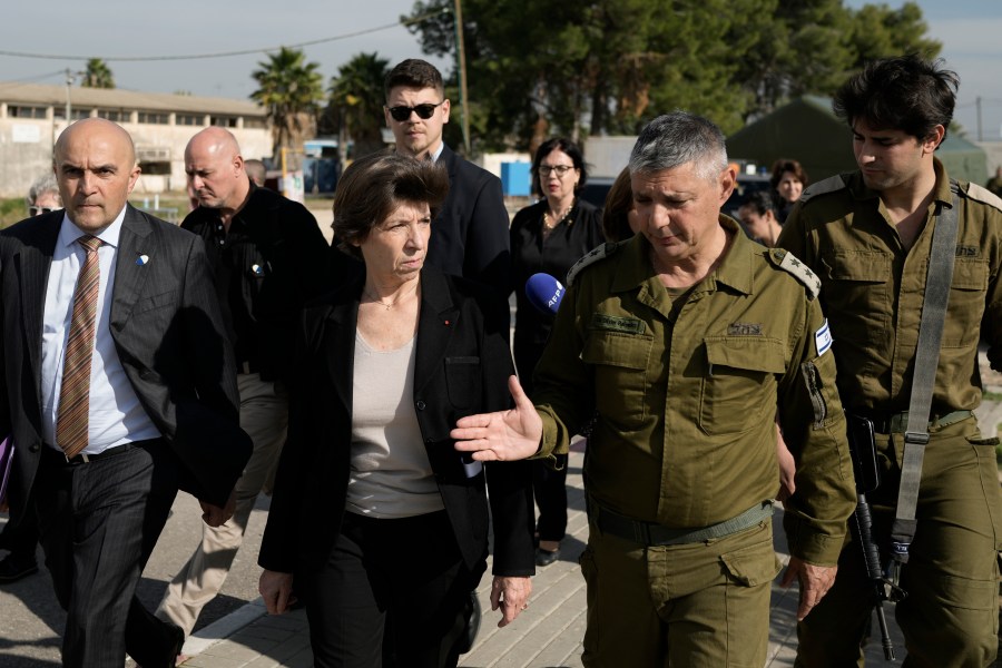 French Foreign Minister Catherine Colonna, center left, talks with Israeli Col. Olivier Rafowicz as she arrives at the Shura military base, central Israel Sunday Dec. 17, 2023. (AP Photo/Leo Correa)