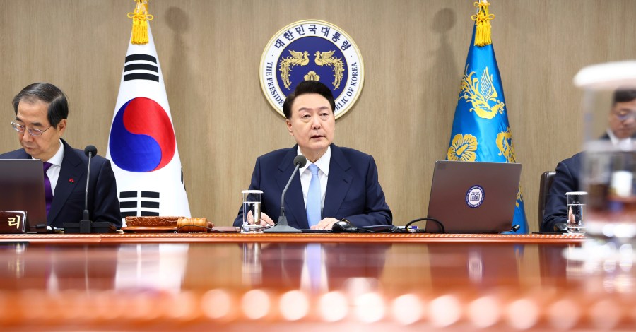 South Korean President Yoon Suk Yeol, center, speaks during a Cabinet Council meeting at the presidential office in Seoul, South Korea, Tuesday, Dec. 19, 2023. Yoon said during the meeting on Tuesday that a “nuclear-based, powerful Korea-U.S. alliance” would be formed soon. The president's announcement came after North Korea's state media reported Tuesday that it has tested what it says is an intercontinental ballistic missile launch. (Yonhap via AP)