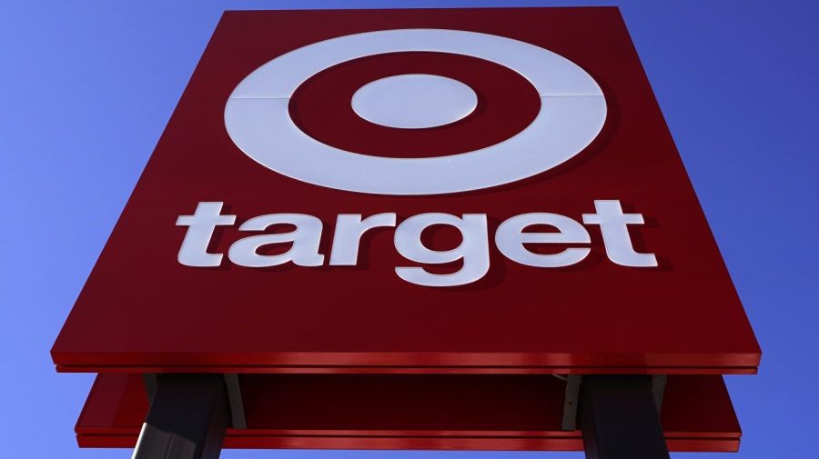 A large red-and-white Target sign is shown from below outside a store.