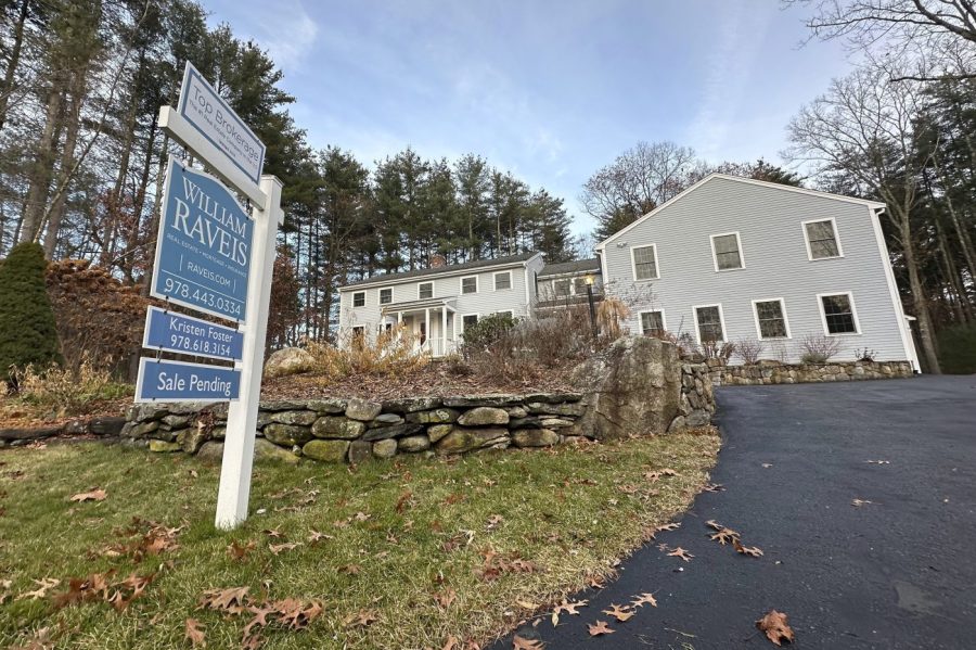 A sale pending sign is displayed in front of a home in Sudbury, Mass. on Saturday, Dec. 2, 2023. On Wednesday, the National Association of Realtors reports on existing home sales for November. (AP Photo/Peter Morgan)