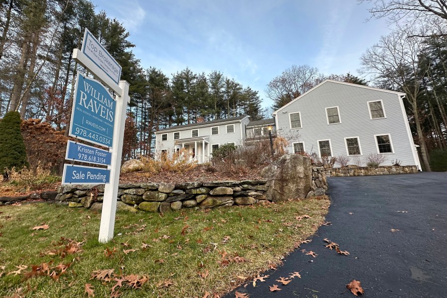 A sale pending sign is displayed in front of a home in Sudbury, Mass. on Saturday, Dec. 2, 2023. On Wednesday, the National Association of Realtors reports on existing home sales for November. (AP Photo/Peter Morgan)