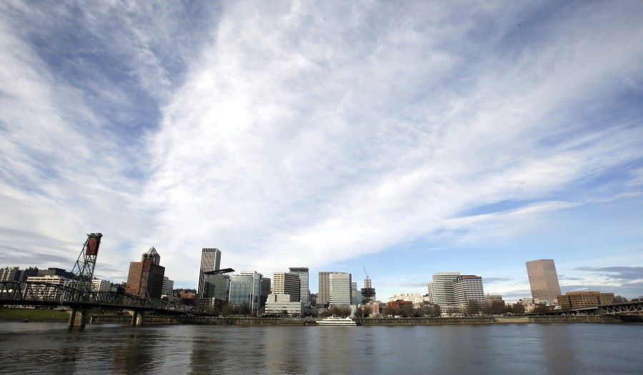 FILE - The Portland, Ore., skyline is visible on the bank of the Willamette River, Dec. 3, 2014. A state appeals court in Oregon ruled Wednesday, Dec. 20, 2023, that a state program designed to limit and drastically reduce greenhouse gas emissions from fossil fuel companies is invalid. (AP Photo/Don Ryan, File)