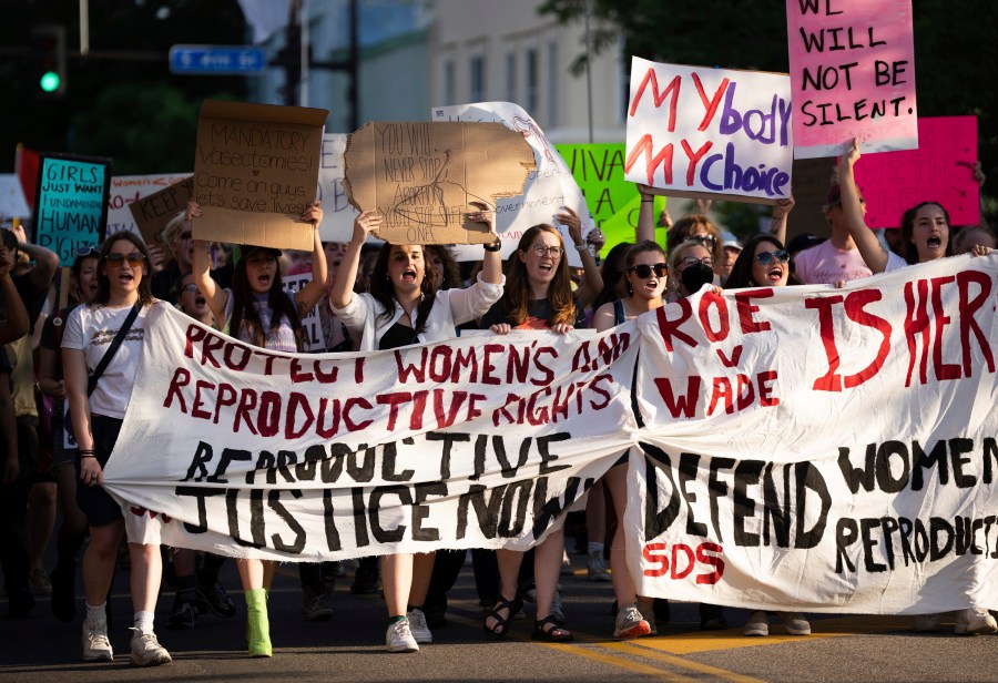 FILE - A large crowd marches on Cedar Avenue to downtown during a University of Minnesota student led protest in Minneapolis, Minn., after the Supreme Court overruled Roe v Wade on June 24, 2022. Attorneys for a woman who was denied emergency contraception in 2019 told the Minnesota Court of Appeals the pharmacist who refused to fill the prescription discriminated against her on the basis of her sex. But an attorney for the central Minnesota pharmacist said Thursday, Dec. 21, 2023, his refusal to provide the drug due to his religious beliefs was not a violation of state and federal law. A jury ruled last year that the pharmacist did not discriminate against the woman. The panel of three judges has 90 days to rule on the appeal. (Renée Jones Schneider/Star Tribune via AP)