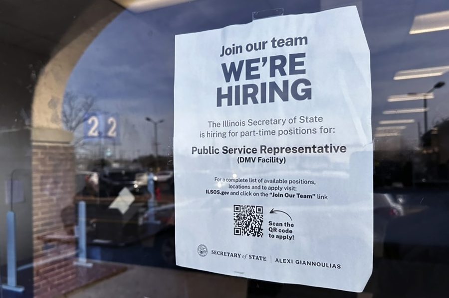 A hiring sign is displayed at the Department of Motor Vehicles office in Deerfield, Ill., Tuesday, Dec.12, 2023. On Thursday, the Labor Department reports on the number of people who applied for unemployment benefits last week. (AP Photo/Nam Y. Huh)