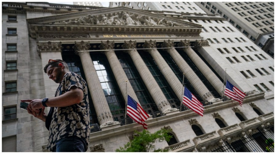 Pedestrians walk past the New York Stock Exchange building.