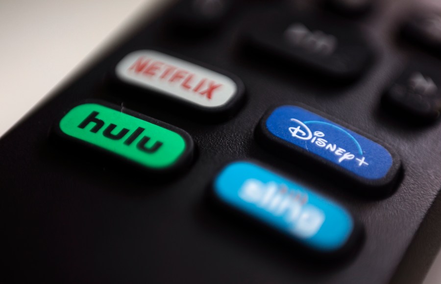 FILE - The logos for streaming services Netflix, Hulu, Disney Plus and Sling TV are pictured on a remote control on Aug. 13, 2020, in Portland, Ore.