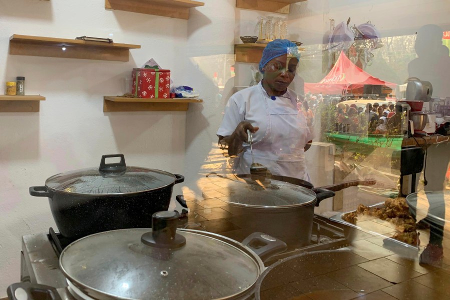 Chef Failatu Abdul-Razak attempts to break a world record for marathon cooking in Tamale, northern Ghana on Friday Jan. 5, 2024. Failatu Abdul-Razak had cooked local dishes non-stop for over 110 hours as of Friday afternoon at a city hotel as part of her effort to surpass the Guinness World Record for a cook-a-thon of 119 hours and 57 minutes held by Irish chef Alan Fisher. (AP Photo)