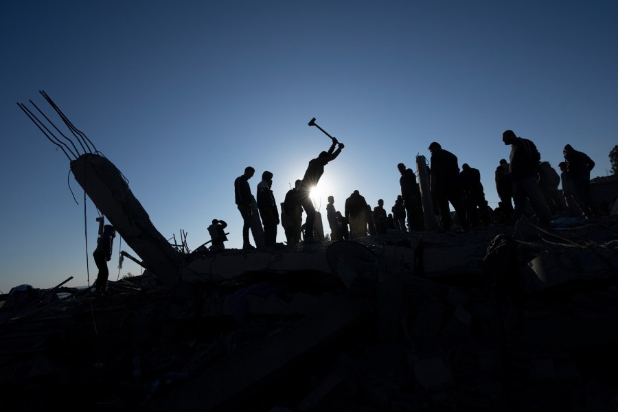 Palestinians search for bodies and survivors in the rubble of a house destroyed in an Israeli airstrike, in Rafah, southern Gaza Strip, Sunday, Jan. 7, 2024. (AP Photo/Fatima Shbair)