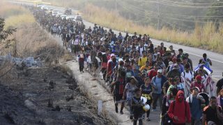 Migrants walk along the highway through Arriaga, Chiapas state in southern Mexico, Monday, Jan. 8, 2024, during their journey north toward the U.S. border.