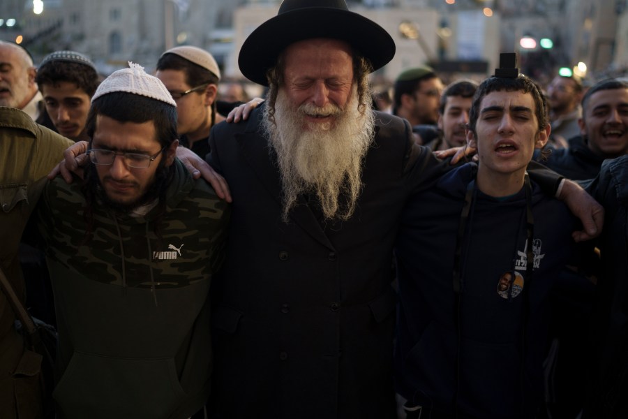 People attend a mass public prayer calling for the hostages held in the Gaza Strip to be released in front of the Western Wall, the holiest site where Jews can pray, in Jerusalem's Old City, Israel, Wednesday, Jan. 10, 2024. In its Oct. 7 attack, Hamas and other militants took captive roughly 250 people, including men, women, children and older people. Around 110 people have been released and some 110 remain, along with about 20 people who were killed while in captivity, Israeli authorities say. (AP Photo/Leo Correa)