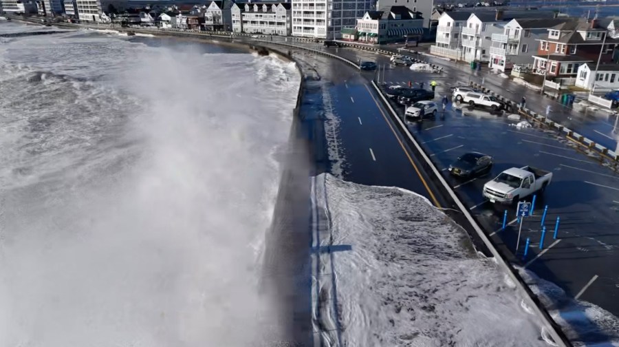 This image provided by Henry Swenson, waves crash against the road as flood waters cover the street at Hampton Beach, N.H. on Wednesday, Jan. 10, 2024. A major storm drenched the Northeast and slammed it with fierce winds, knocking out power to hundreds of thousands following a bout of violent weather that struck most of the U.S.(Henry Swenson via AP)