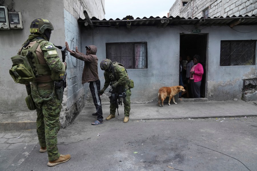 Soldiers stop and search a pedestrian for weapons as they patrol residential areas in northern Quito, Ecuador, Thursday, Jan. 11, 2024. President Daniel Noboa decreed Monday a national state of emergency due to a wave in crime, a measure that lets authorities suspend people's rights and mobilize the military. The government also imposed a curfew.