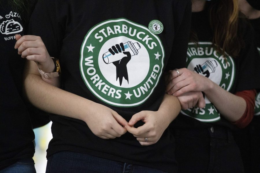 FILE - Starbucks employees and supporters link arms during a union election watch party Dec. 9, 2021, in Buffalo, N.Y. The Supreme Court on Friday, Jan. 12, 2024 agreed to hear an appeal from Starbucks in a dispute with the National Labor Relations Board over efforts by workers to unionize at a store in Memphis, Tennessee.(AP Photo/Joshua Bessex, File)