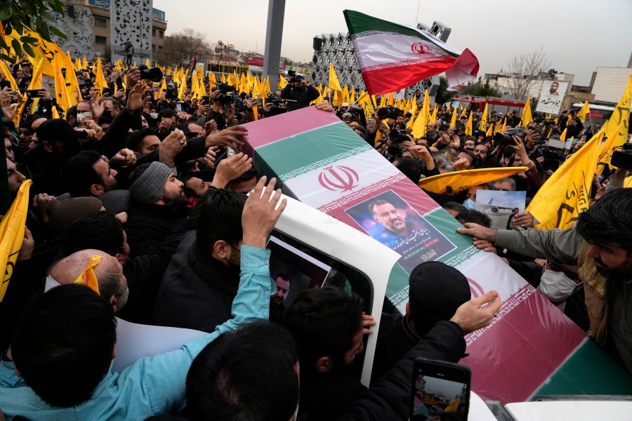 FILE - Iranian mourners carry the flag-draped coffin of Seyed Razi Mousavi, a high ranking Iranian general of the paramilitary Revolutionary Guard, who was killed in an alleged Israeli airstrike in Syria on Monday, during his funeral ceremony in Tehran, Iran, Thursday, Dec. 28, 2023. Iran announced late Monday, Jan. 15, 2024, that it had launched strikes against a “spy headquarters and the gathering of anti-Iranian terrorist groups” shortly after missiles hit an area near the U.S. consulate in Irbil, the seat of Iraq’s semi-autonomous Kurdish region. (AP Photo/Vahid Salemi, File)