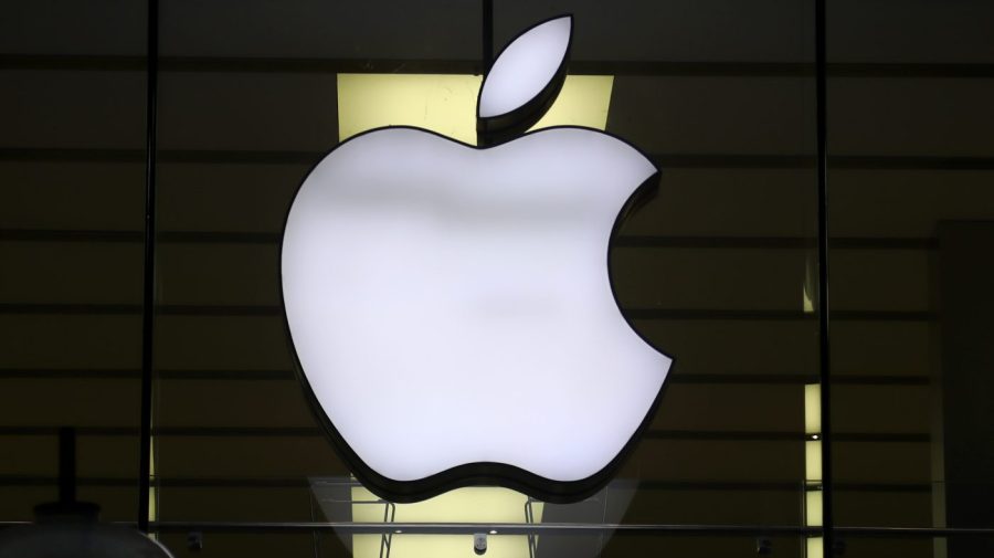 The Apple logo is illuminated at a store in the city center of Munich, Germany, Dec. 16, 2020.