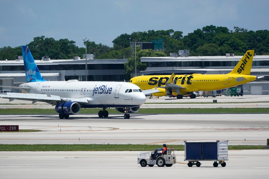 FILE - A JetBlue Airways Airbus A320, left, passes a Spirit Airlines Airbus A320 as it taxis on the runway, Thursday, July 7, 2022, at the Fort Lauderdale-Hollywood International Airport in Fort Lauderdale, Fla. JetBlue and Spirit Airlines are appealing a judge's ruling that is blocking their planned merger. The airlines said Friday, Jan. 19, 2024, they have filed a notice of appeal with the 1st U.S. Circuit Court of Appeals. (AP Photo/Wilfredo Lee, File)