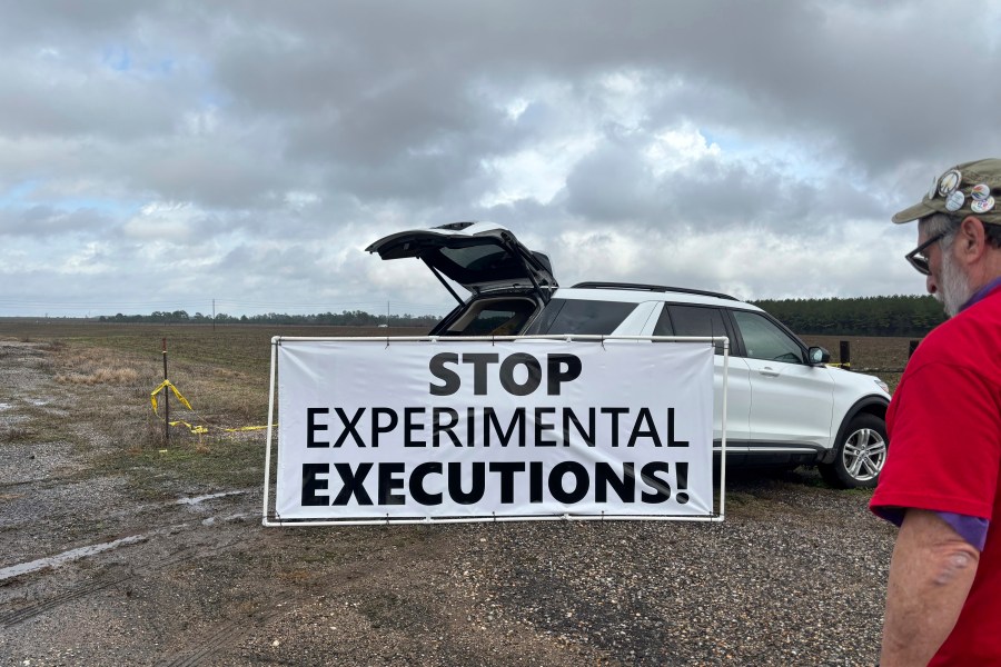 Anti-death penalty activists place signs along the road heading to Holman Correctional Facility in Atmore, Ala., ahead of the scheduled execution of Kenneth Eugene Smith on Thursday, Jan. 25, 2024. The state plans to put Smith to death with nitrogen gas, the first time the new method has been used in the United States. (AP Photo/Kim Chandler)