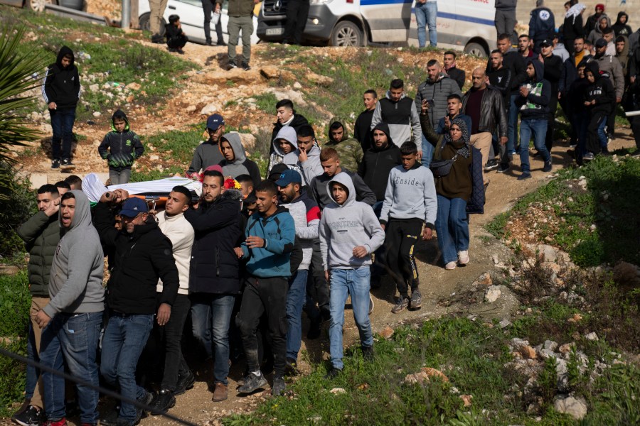 Mourners carry the body of Palestinian Abdel Rahman Hamed, 18, during his funeral in the West Bank town of Silwad, Monday, Jan. 29, 2024. Palestinian authorities say five Palestinians have been killed by Israeli forces in separate shootings across the occupied West Bank on Monday, including Hamed, who was killed during clashes with Israeli border police at his home village of Silwad. (AP Photo/Nasser Nasser)