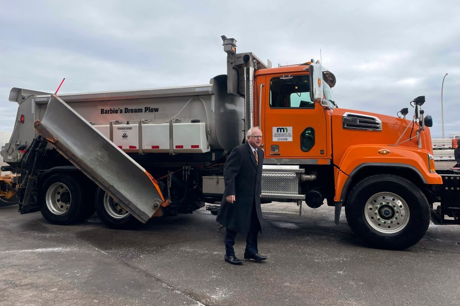 Minnesota Gov. Tim Walz smiles after a ride in a snowplow named "Barbie's Dream Plow", Tuesday, Jan. 30, 2024, in Richfield, Minn. Barbie's Dream Plow was one of eight winning names in Minnesota's fourth annual Name a Snowplow contest. (AP Photo/Trisha Ahmed)