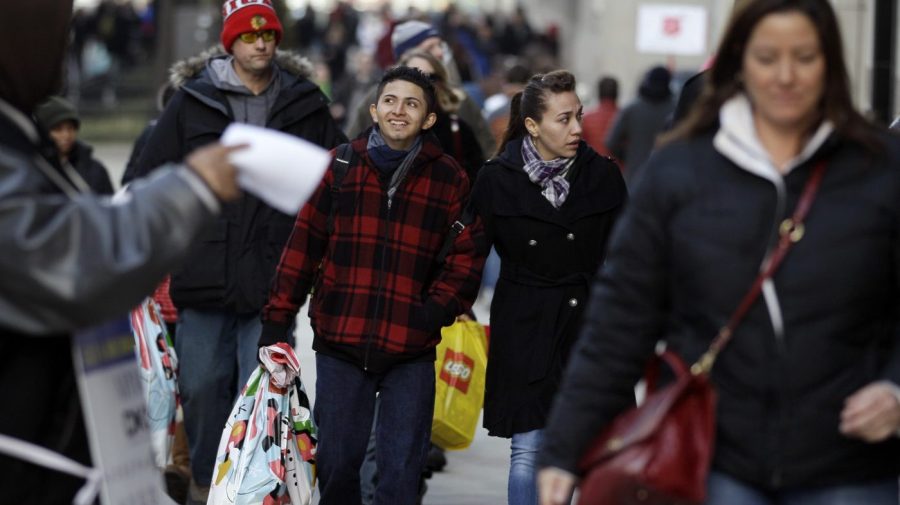 Pedestrians walk along a shopping district in Chicago.