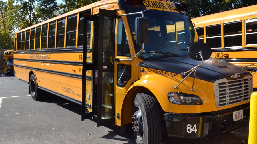 An electric school bus, leased by Beverly Public Schools in Beverly, Mass., rests in a bus yard, Thursday, Oct. 21, 2021, in Beverly, Mass.